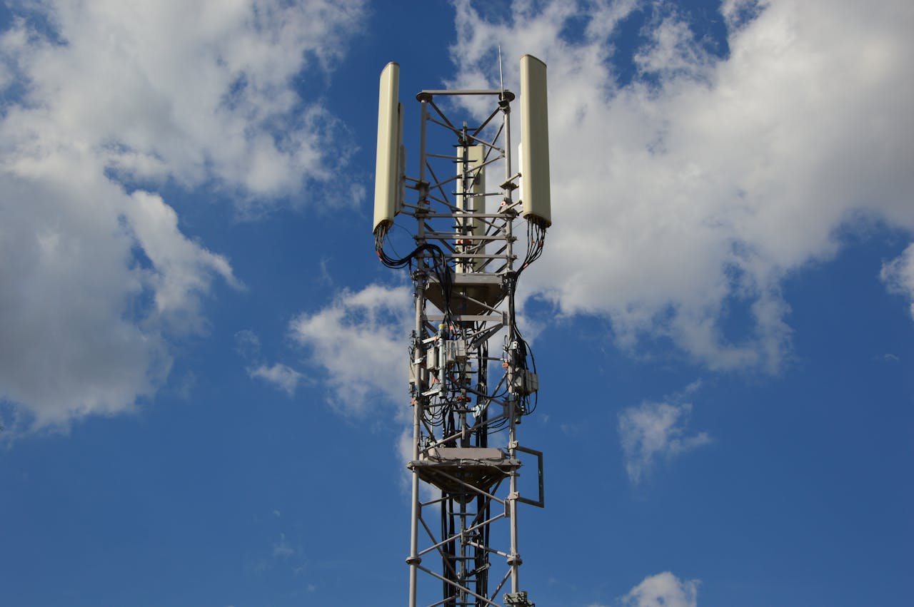 gallery-5 A tall cellular communication tower against a vivid blue sky, symbolizing modern technology.